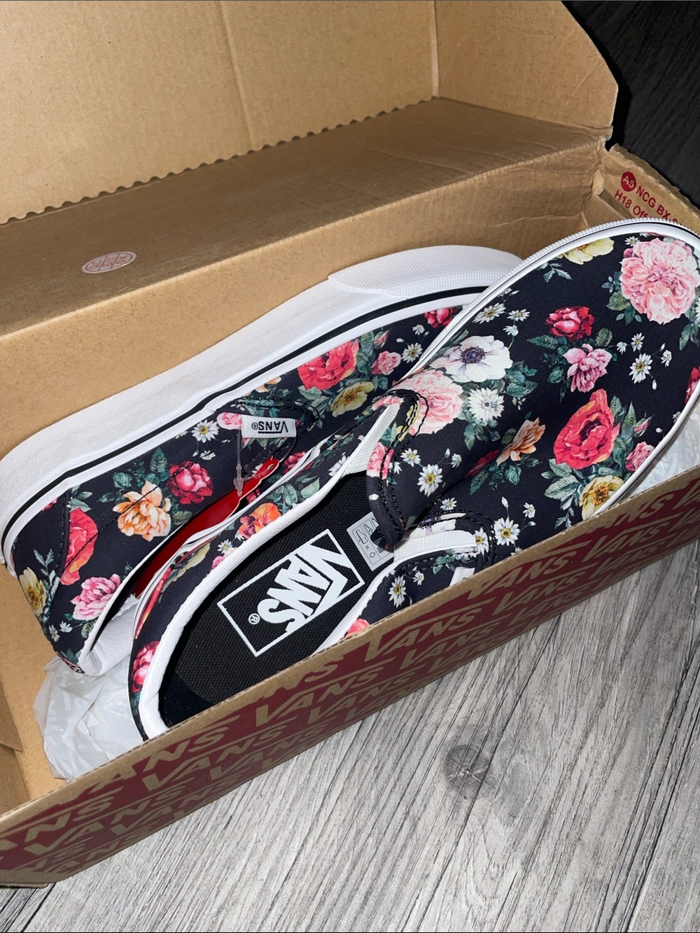 Vans Women’s Floral Slip-On Sneakers in Black with Multicolor Blooms